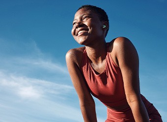 Woman smiling while exercising outside