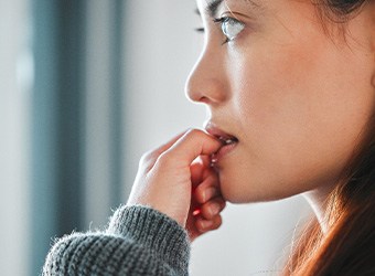 Closeup of woman biting her nails