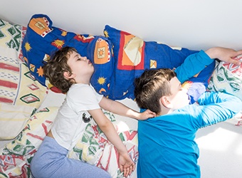 Two children snoring in bed