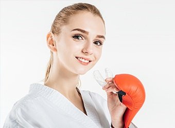 girl putting in mouthguard