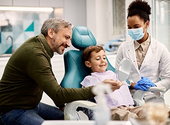 Prince Albert family dentist showing child his smile in mirror