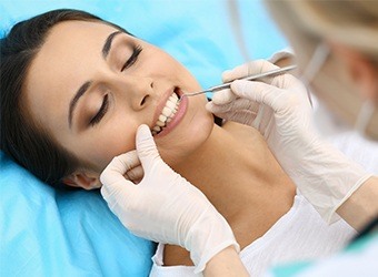 woman getting checked for gum disease