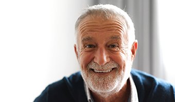 Older man smiling with dental implants in Prince Albert