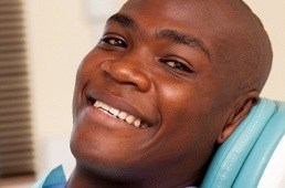 man smiling in exam chair