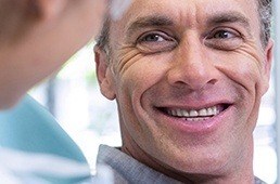 man smiling at dentist