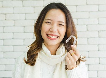 woman showing off invisalign