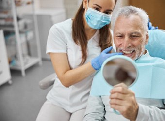 A dentist telling her patient how to care for dental implants
