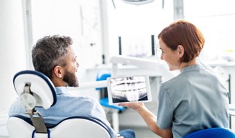 A middle-aged man having a dental checkup with his dentist  