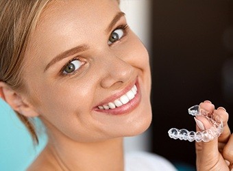 woman holding invisalign