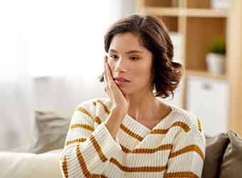 Closeup of woman experiencing toothache at home