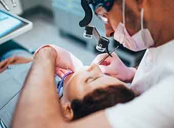 Dentist performing root canal procedure