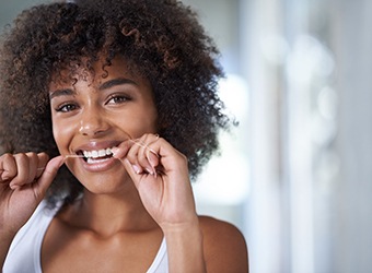 closeup of woman flossing 