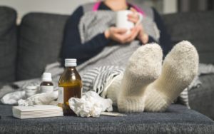 sick person sitting on couch