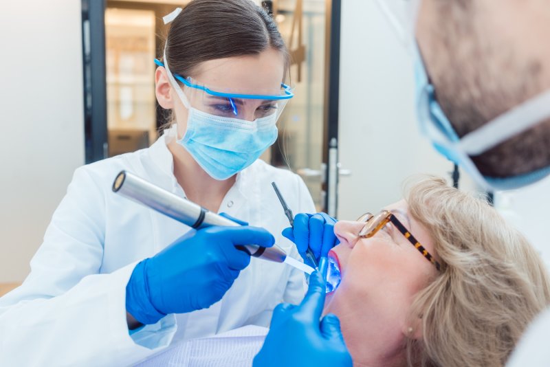 Dentist wearing personal protective equipment during appointment