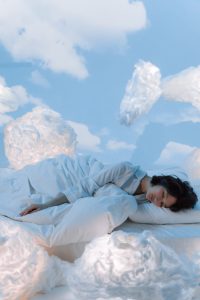 Woman sleeping in the clouds